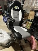 black and white gaming chair with adjustable arms and chair height